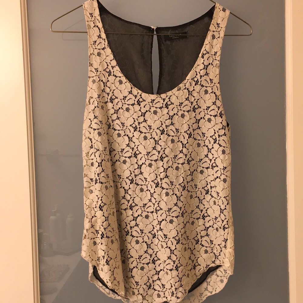 Creme floral lace blouse with black lining.